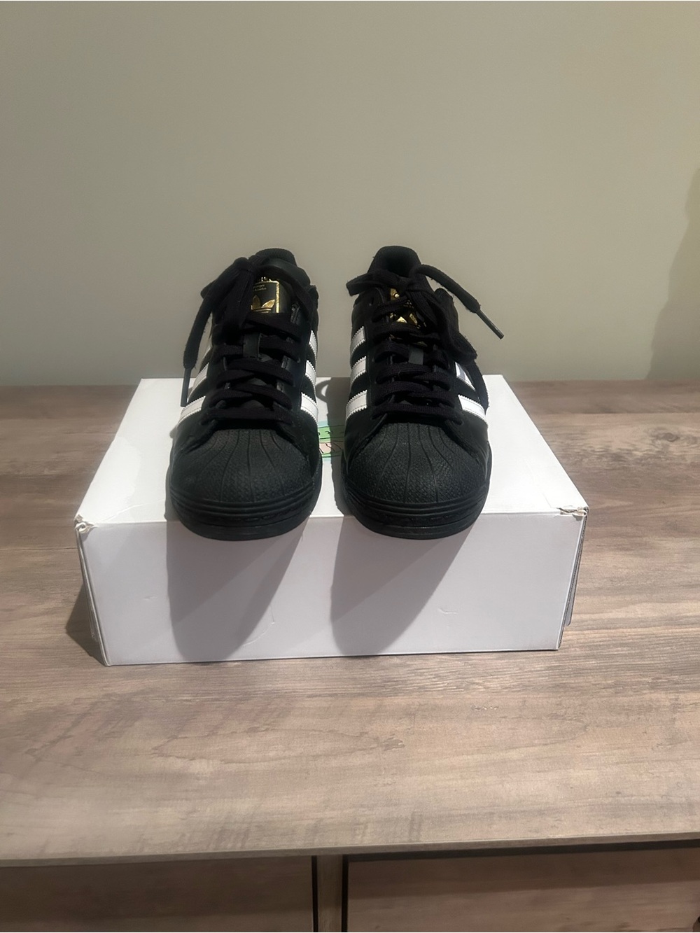 adidas Black Sneakers with White Stripes and Gold Accents